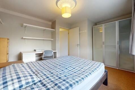 A bright and tidy double bedroom featuring a co...