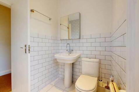 Bright and clean bathroom featuring modern whit...