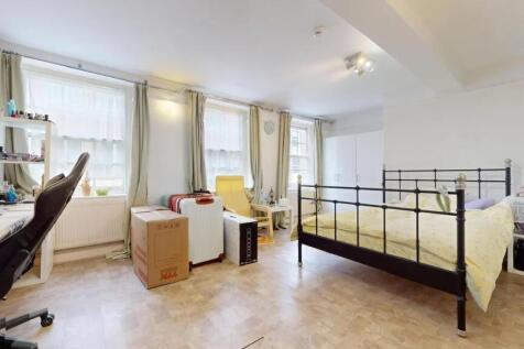 Bright and spacious bedroom featuring a large d...