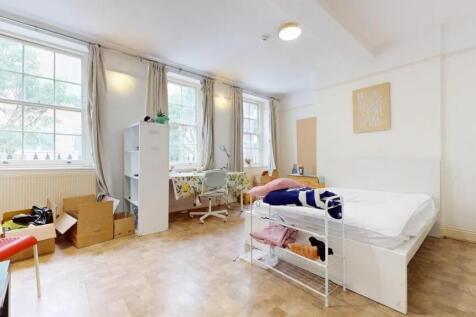Bright and spacious bedroom featuring three lar...