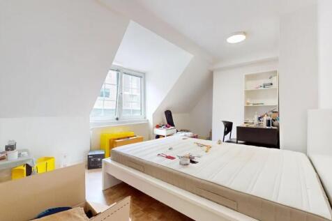 Bright double bedroom with a large window allow...