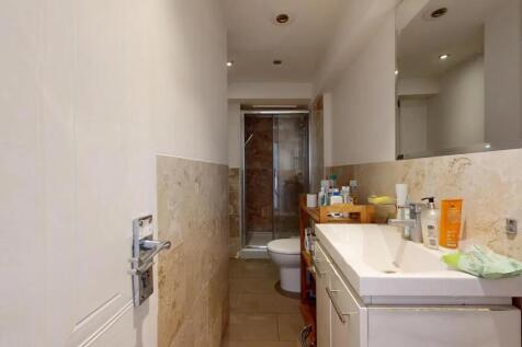 A modern bathroom featuring a clean white sink ...