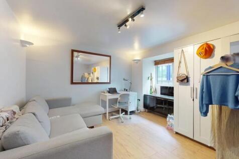 A bright and inviting living room featuring a c...
