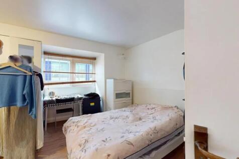 Bright and cozy double bedroom featuring a comf...
