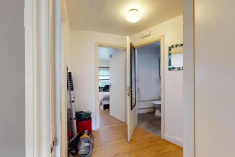 A bright and functional hallway with light wood...