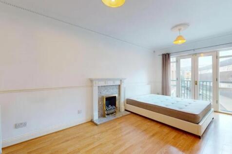 A bright and spacious master bedroom featuring ...