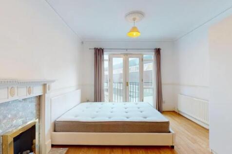Bright and spacious master bedroom featuring a ...