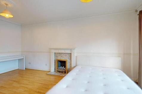 Bright and spacious master bedroom featuring a ...
