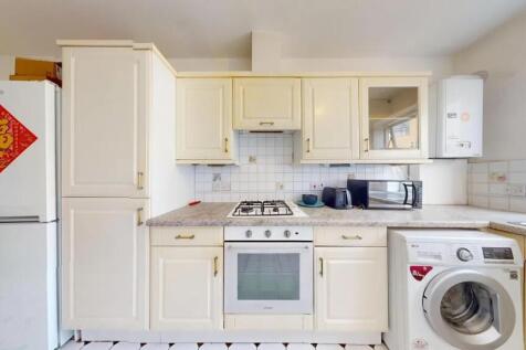 Bright and clean kitchen featuring ample cabine...