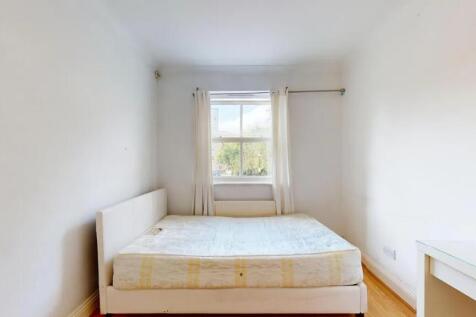 A bright double bedroom featuring a comfortable...