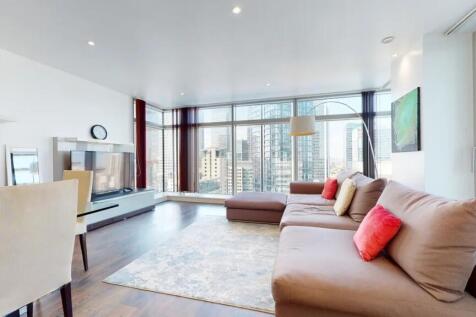 Bright and spacious living room featuring large...