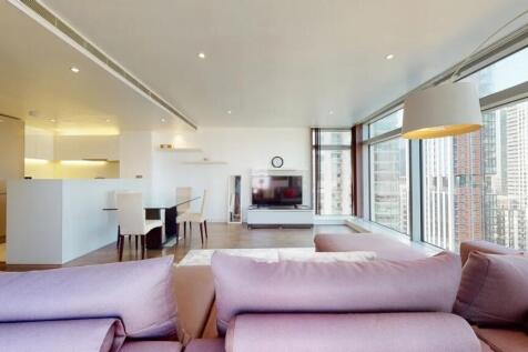 A spacious contemporary living room featuring l...