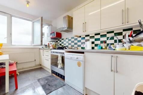 Bright kitchen featuring modern white cabinetry...