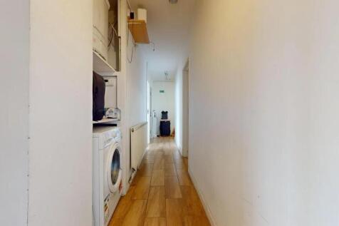 A clean and simple hallway with wooden flooring...