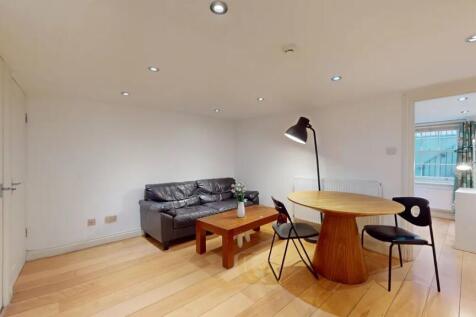 A modern living room featuring a comfortable bl...
