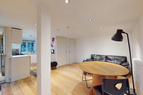 A contemporary living room featuring warm woode...