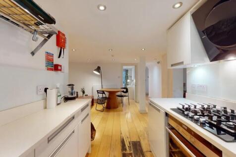 A modern and clean kitchen area featuring sleek...