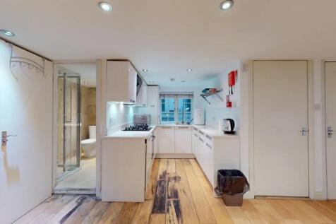 Bright and modern kitchen with sleek white cabi...