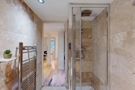 A modern bathroom featuring elegant stone wall ...