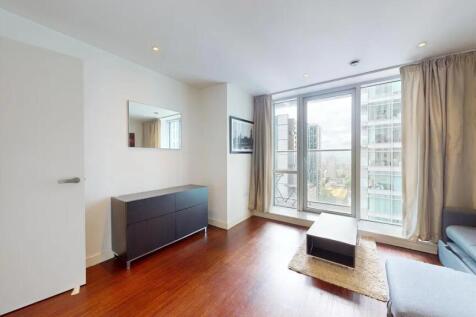 A modern living room featuring sleek wood floor...