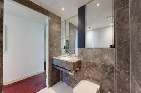 A modern bathroom suite featuring elegant stone...