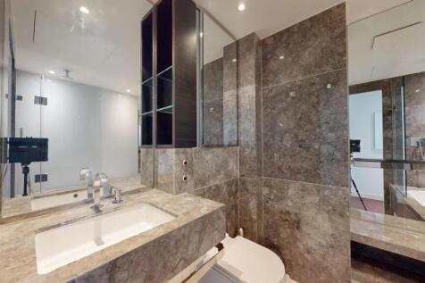 A sleek and modern bathroom suite featuring ele...