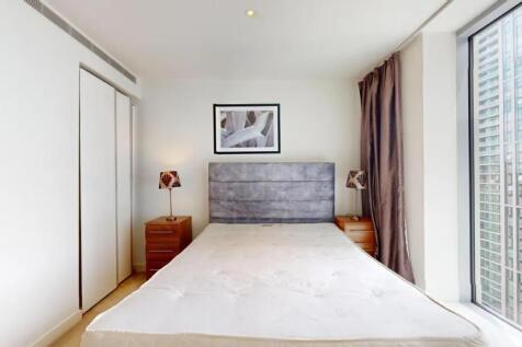 Bright and modern double bedroom featuring a la...