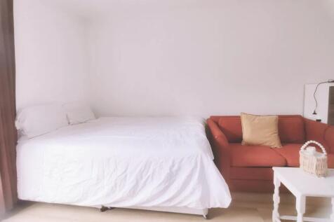 A bright and neatly arranged double bedroom fea...