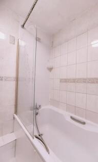 A clean and functional bathroom suite featuring...