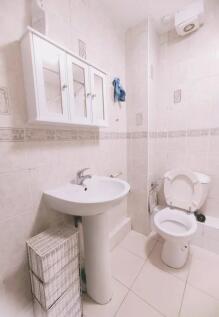 Bright and clean bathroom featuring a pedestal ...