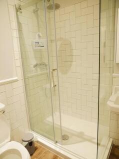 Bright and modern bathroom featuring a spacious...