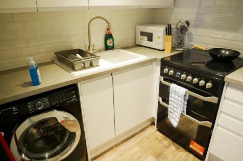 Modern kitchen area featuring a sleek black ele...