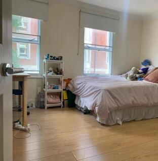 Bright and cozy double bedroom featuring light ...