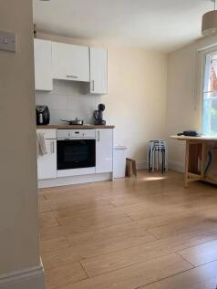 Bright and tidy kitchen featuring modern white ...