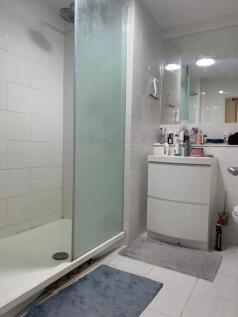 Bright and modern bathroom featuring a walk-in ...