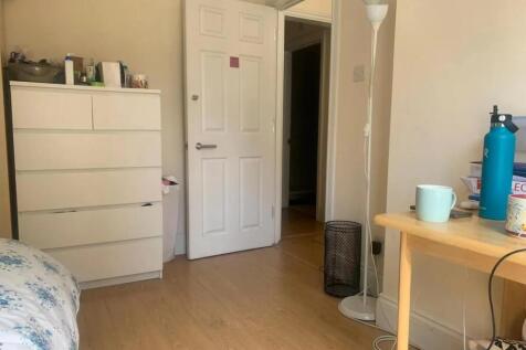 A tidy and softly lit room featuring light wood...