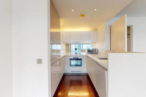 Bright and modern kitchen featuring sleek white...