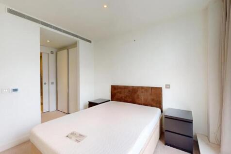 A bright double bedroom featuring a comfortable...