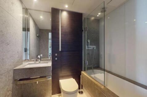 Modern bathroom suite featuring sleek stone fin...