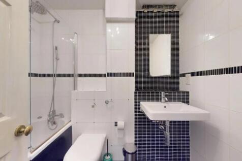 Modern bathroom suite featuring a combined bath...