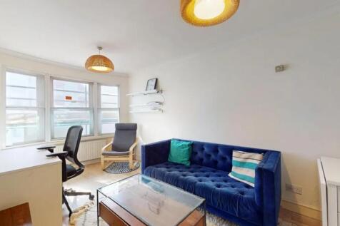 Bright living room featuring a stylish deep blu...