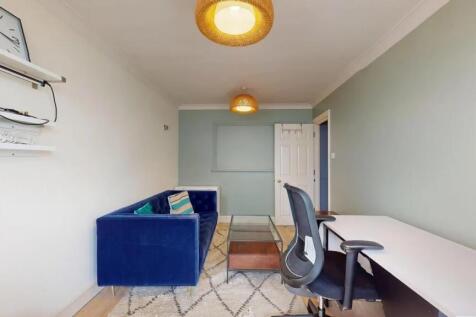A stylish communal lounge featuring a deep blue...