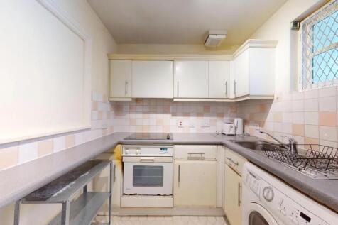 Bright kitchen with ample countertop space and ...