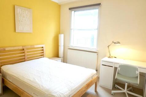 Bright and welcoming double bedroom featuring a...