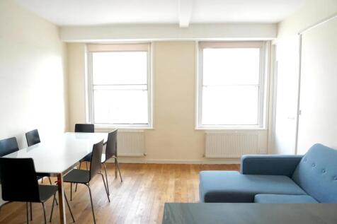 Bright and airy living room featuring two large...
