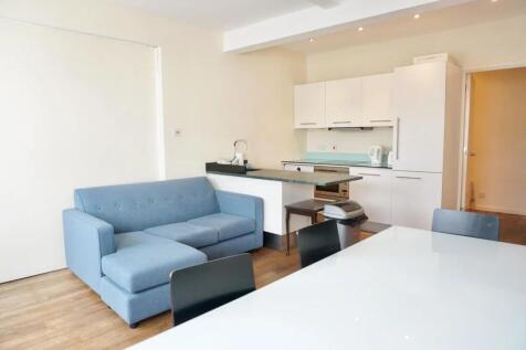 Bright and modern living room featuring a comfo...