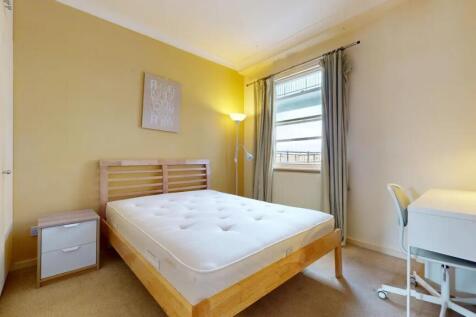 Bright and cozy double bedroom featuring a comf...