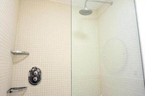 Bright and modern bathroom shower area featurin...