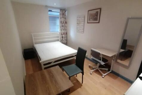 A tidy and practical double bedroom featuring a...