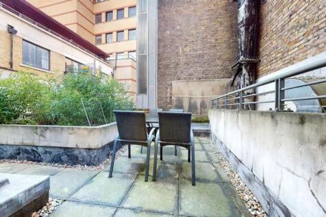 A compact urban garden space featuring a small ...